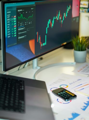 Screen with financial charts. Stock quotes. Currency and cryptocurrency exchange. Calculator on documents. Equity Swing Ideas